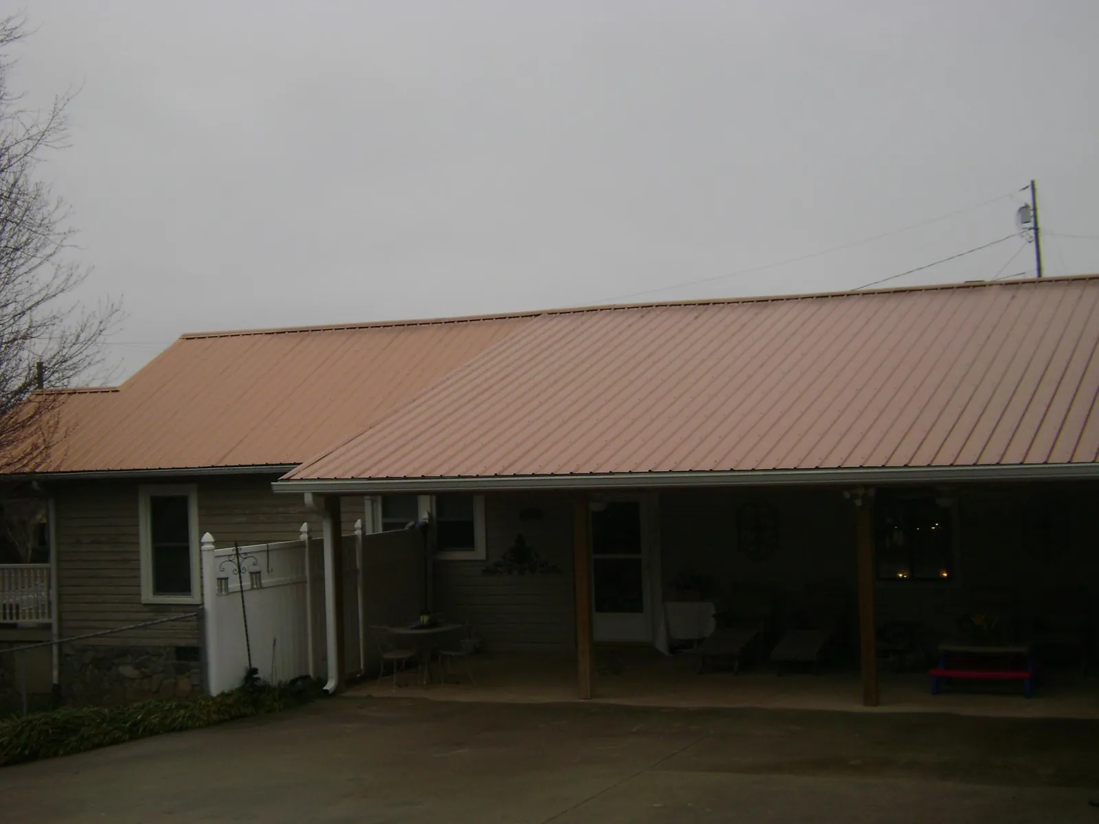 Copper toned metal roof over a wide covered patio in Lake Elmo